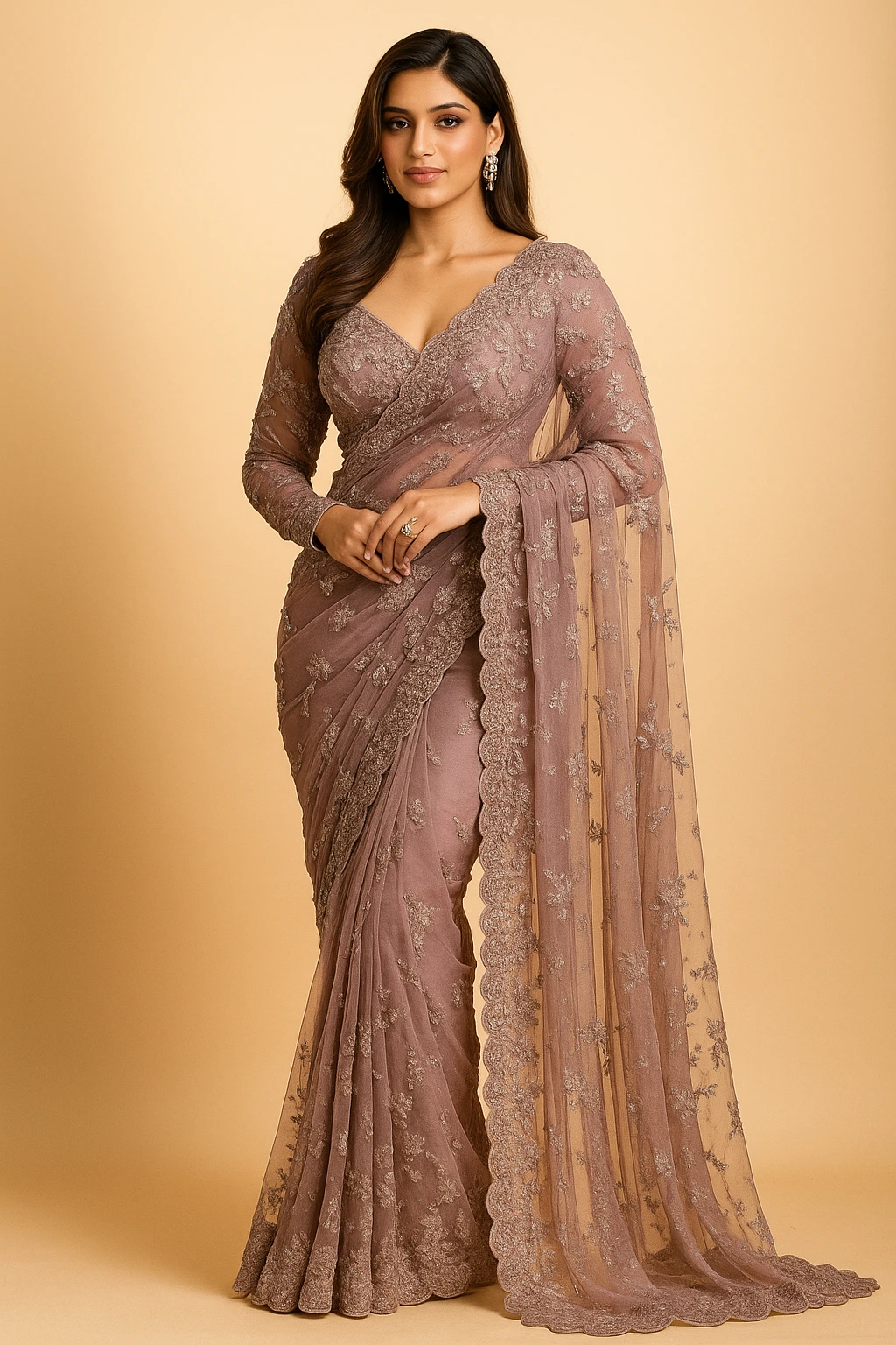 Elegant woman wearing a mauve embroidered net saree with scalloped lace border and long-sleeve blouse in a luxury studio setting